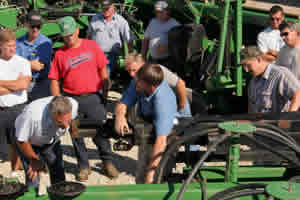 Phil Needham provides a technical drill set-up and calibration clinic to a group of farmers in Southern Indiana.
